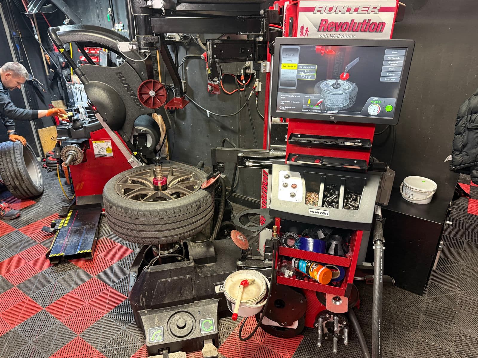 Hunter Revolution tire changer and screen with a low-profile tire on a bronze wheel