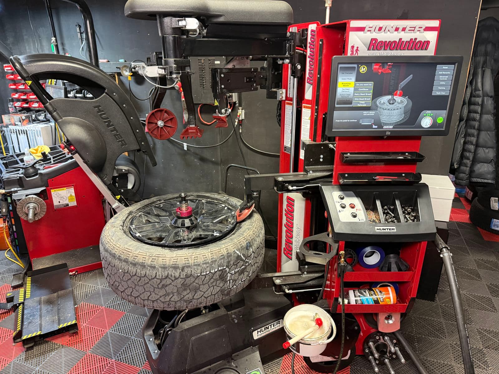 Truck tire on a black wheel on the Hunter Revolution tire changer