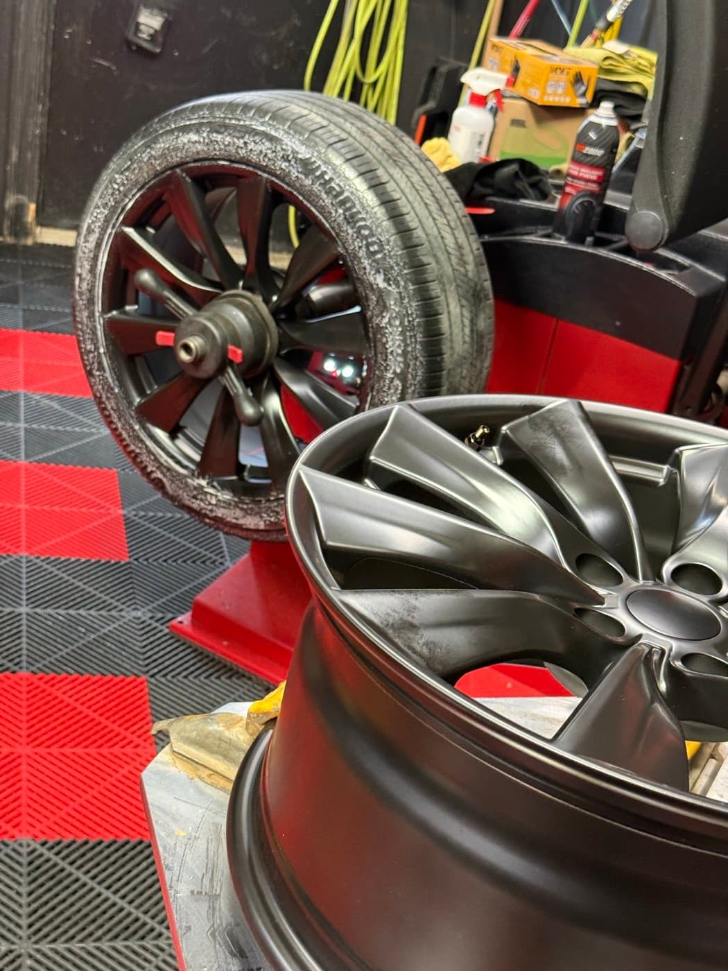 Salt-corroded wheel behind a clean new rim at PitStop & Go: what a few salty winters do