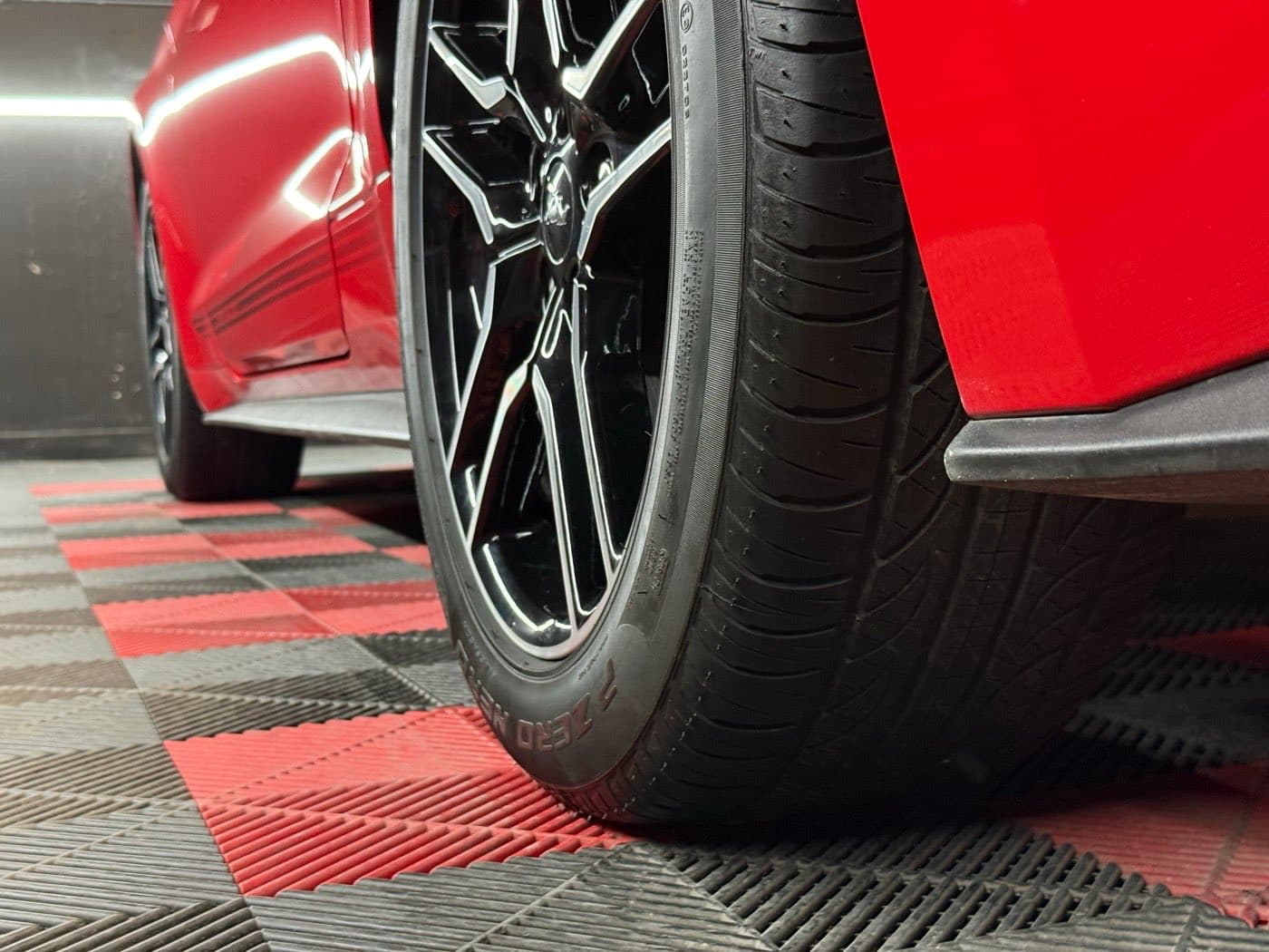 Closeup of the tread grooves on a Pirelli P Zero Nero: depth is the first thing to check