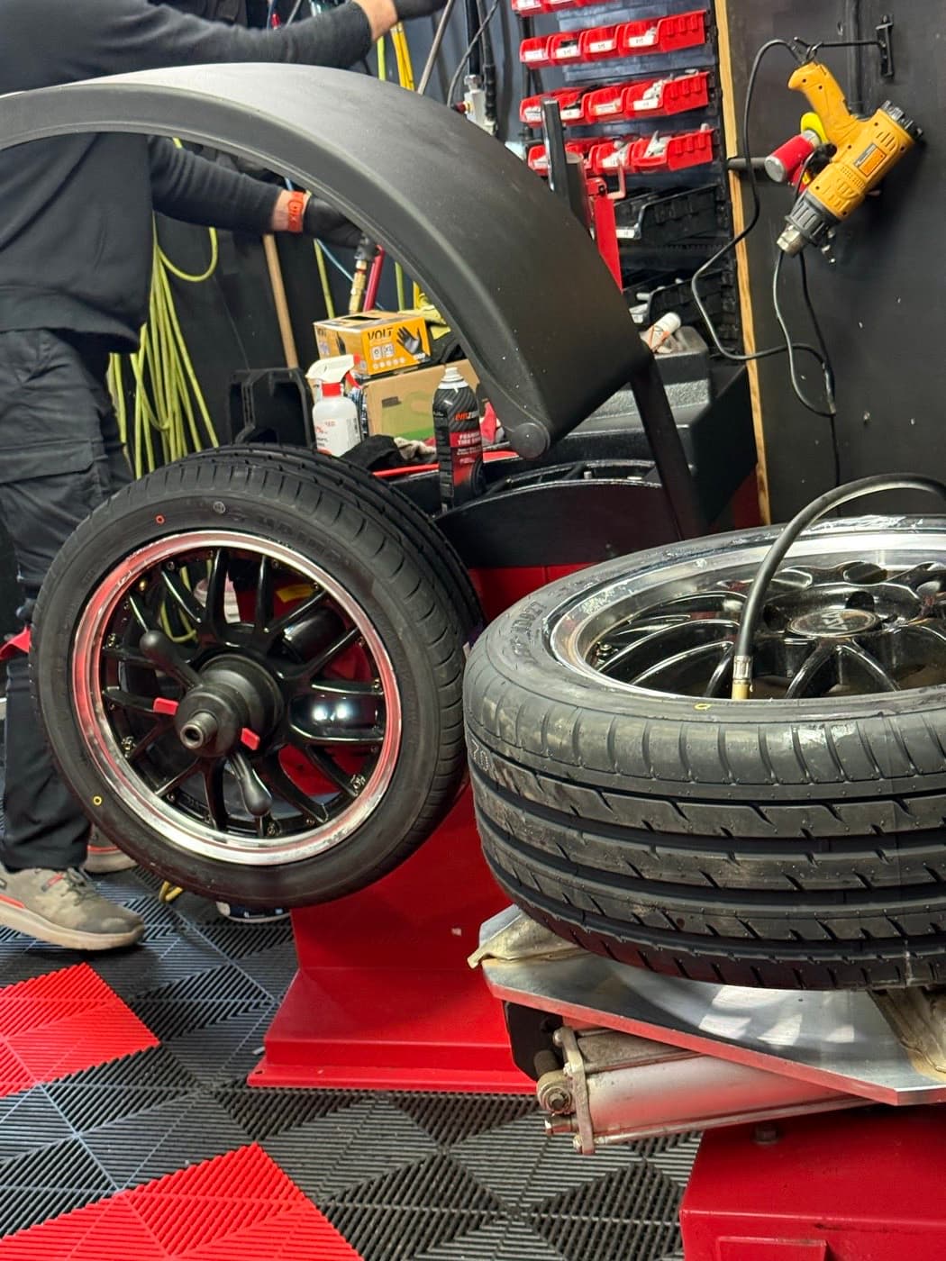 Two wheel sets staged in the PitStop & Go bay during a winter tire changeover in Fredericton