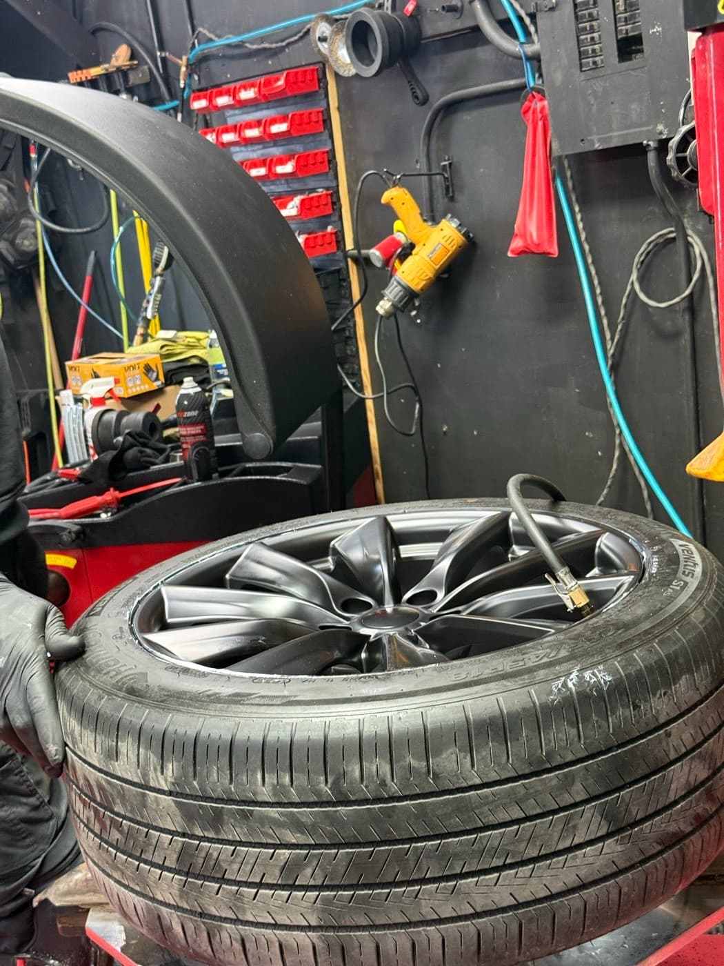 Topping up air pressure on an SUV tire at PitStop & Go: a flat that still holds air can often be saved