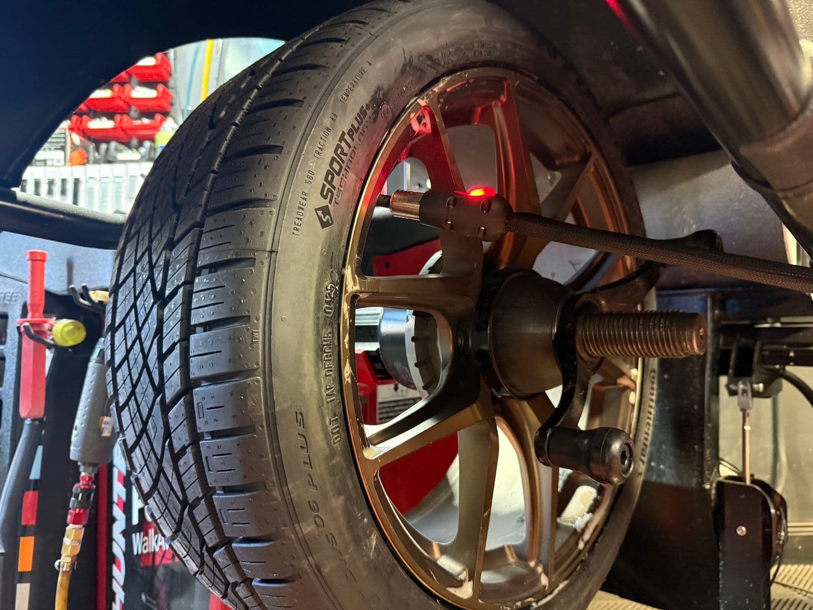 Bronze alloy wheel on the Hunter balancer with a laser marking where the weight goes