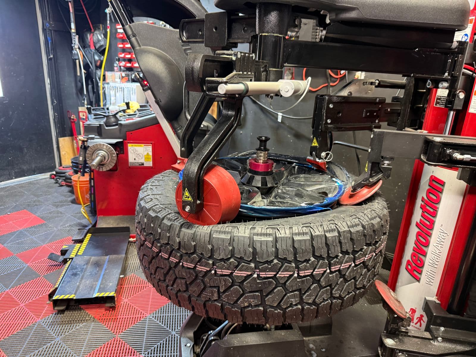 All-terrain truck tire being mounted on the Hunter Revolution tire changer