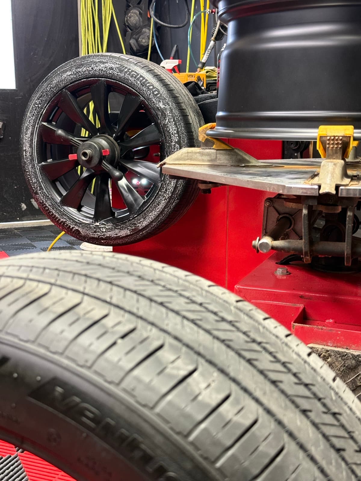 Tire being mounted on the machine during an off-rim tire change in Fredericton