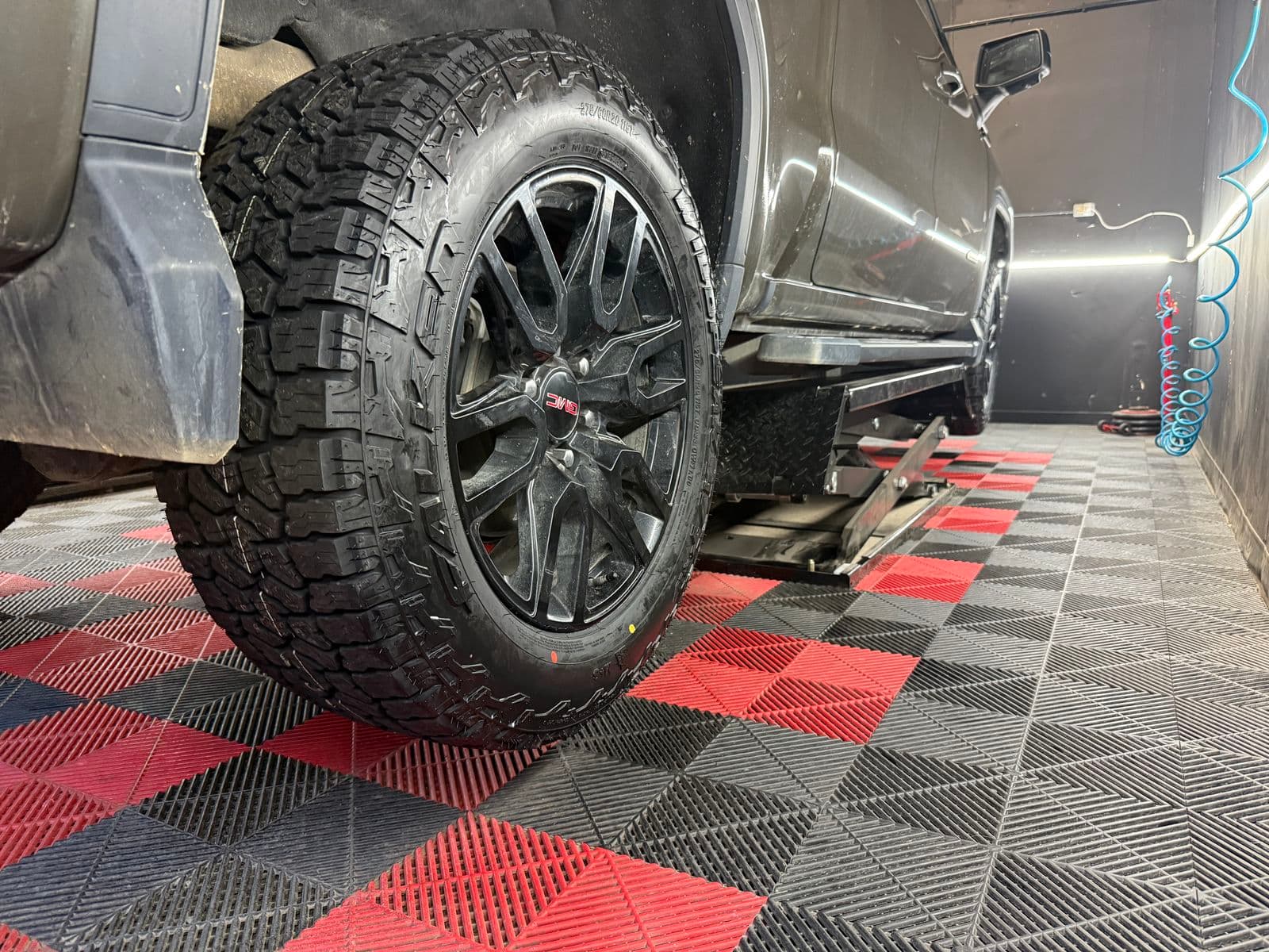 All-terrain tires installed on a pickup in the PitStop & Go bay