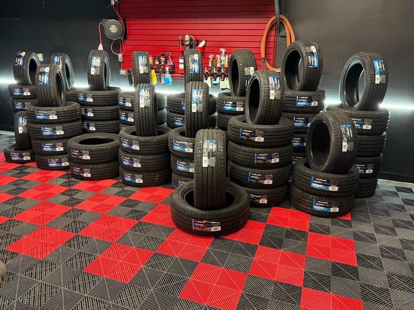 Stacks of Sailun tires in stock on the shop floor at PitStop & Go, Fredericton
