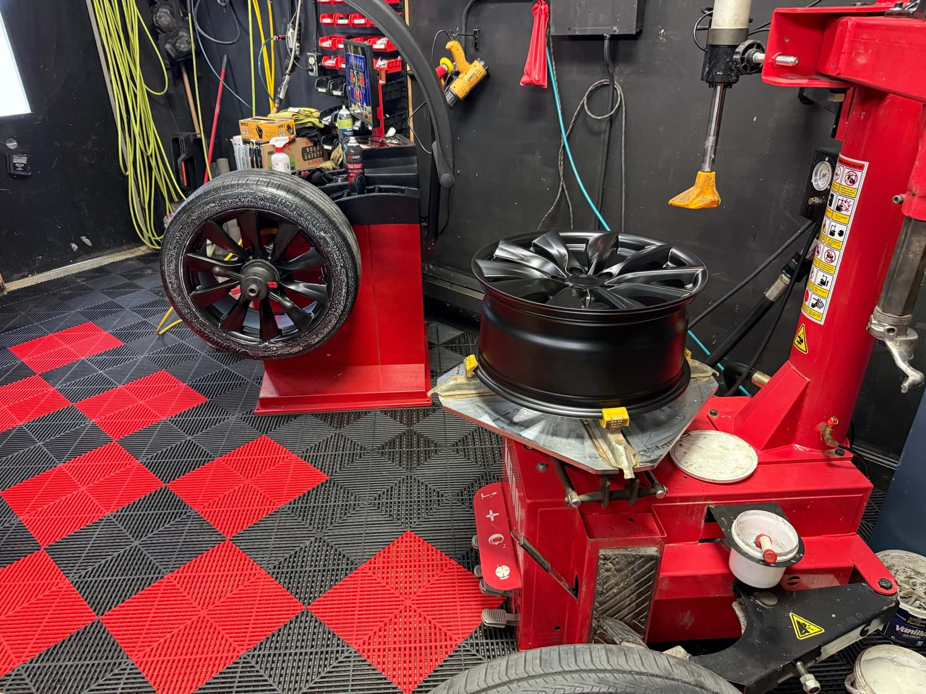 The shop floor at PitStop & Go with the tire changer and the computer balancer side by side