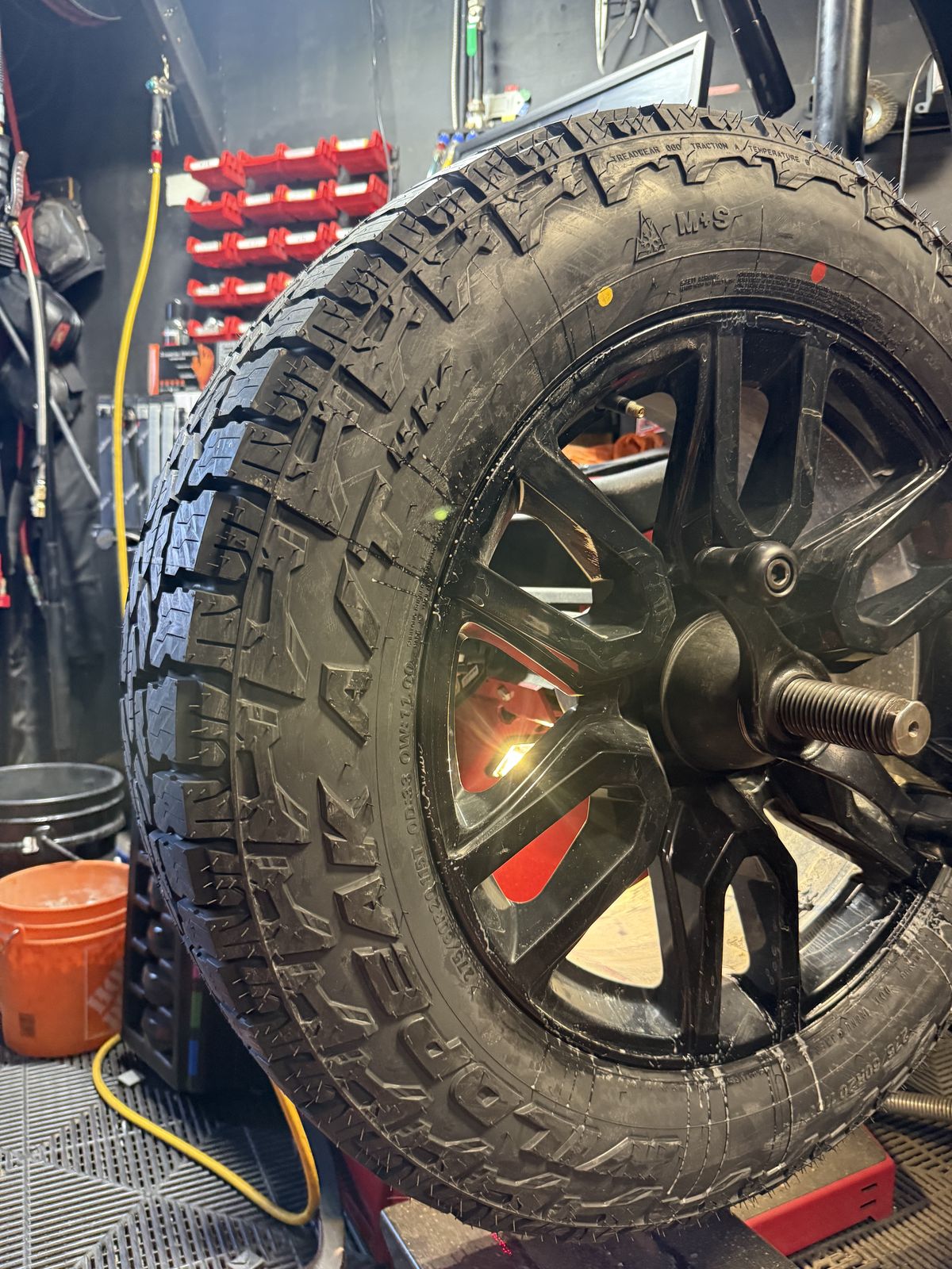 New all-terrain tire on a black wheel on the Hunter balancer
